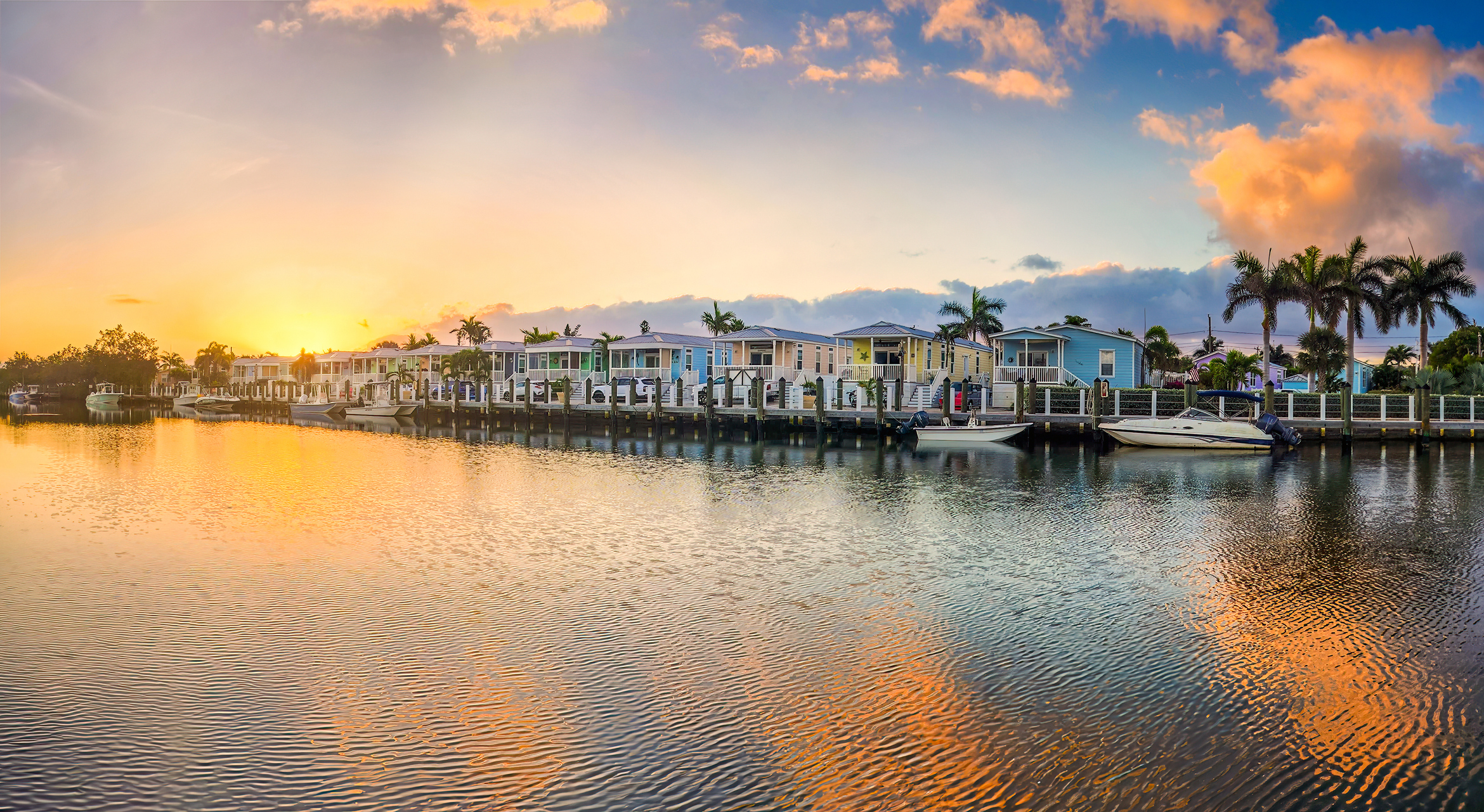The sun sets behind houses in Key West